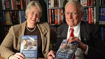 Mayor Annise Parker and Dr. Denton A. Cooley hold copies of 100,000 hearts.