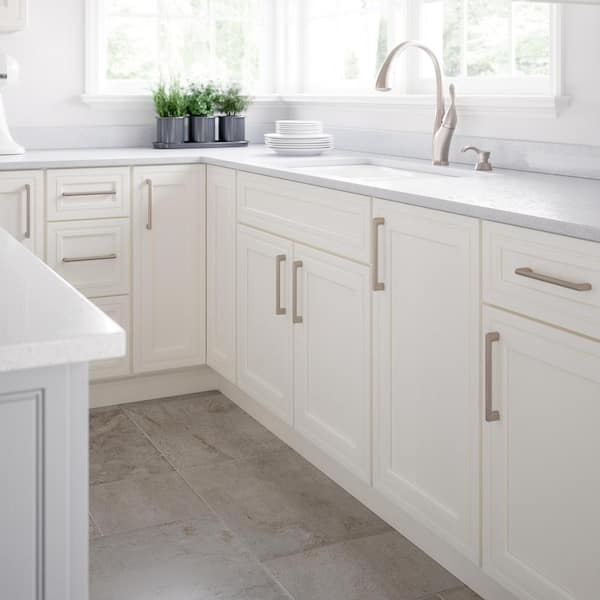 Standard package: white shaker cabinets with satin nickel pulls and Sea Salt laminate counters