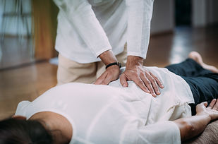 Therapist massaging woman’s back. Woman getting shiatsu back massage..jpg