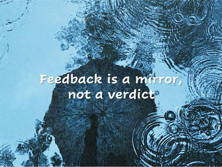 erson's reflection in rain-rippled water representing feedback as a mirror for self-awareness