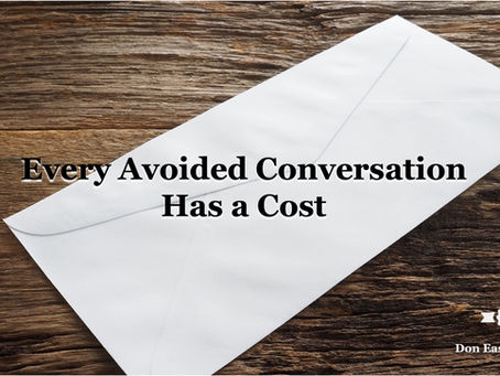 White envelope resting on a weathered wooden surface. Text reads: "Every Avoided Conversation Has a Cost." Don Eash Coaching logo in the bottom right corner.