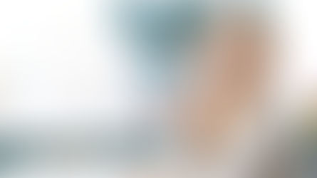 Young girl looking through magnifying glass with smile representing curiosity as the beginning of wisdom