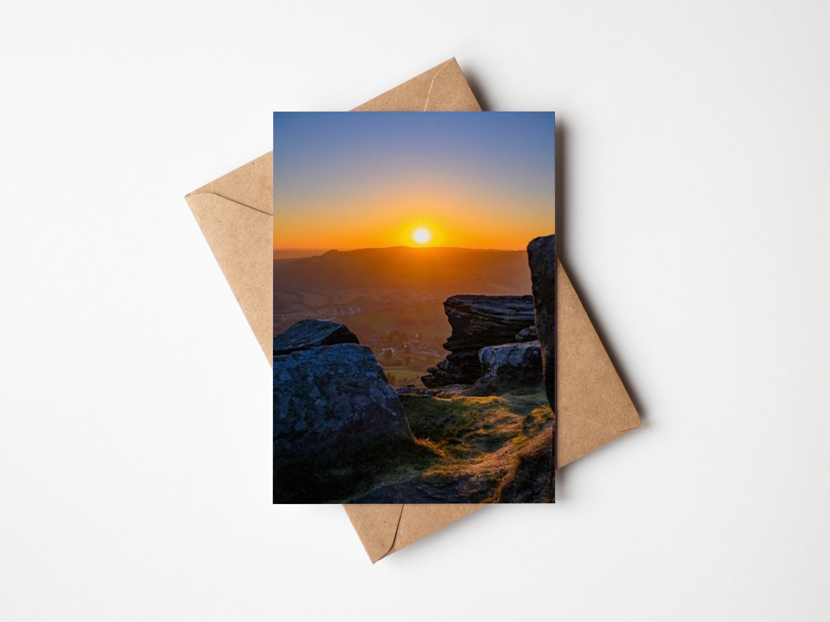 Sunset over Curbar edge framed by rocks at Calver