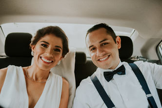 Couple laughing during the car ride in Madrid streets during romantic elopement photography session.