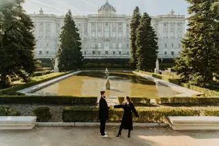 Engaged couple holding hands in Sabatini Gardens Madrid