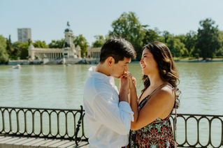Couple kissing after surprise engagement proposal near the Retiro Lake in Madrid.