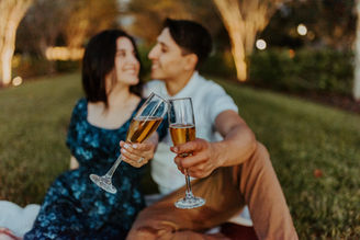 Couple toasting after emotional engagement celebration in Madrid with laughter and tears of joy