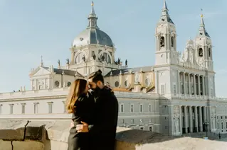 Engagement embrace with Almudena Cathedral in the background Madrid
