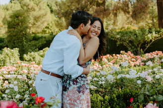 Intimate marriage proposal in the Rose Garden of Retiro Park Madrid filled with flowers