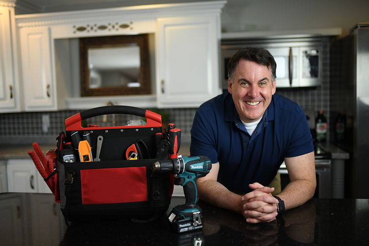 Business owner smiling with tool bag