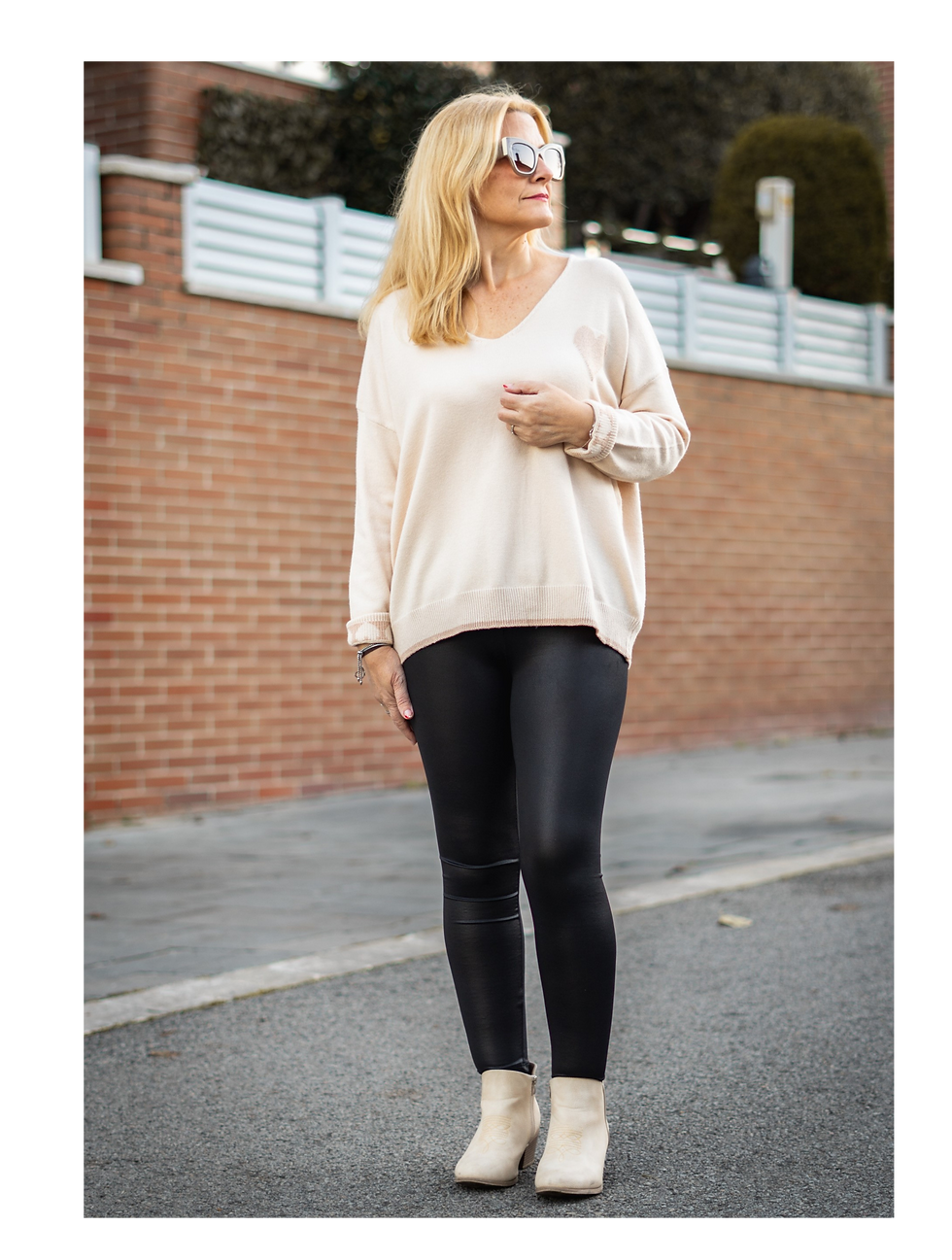 Modelo con suéter beige y leggings negros