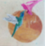 An embroidered hummingbird drinking from a pink flower in front of a gold sun.