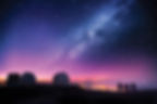 Stargazing at Mauna Kea beneath the Milky Way, observatories in sight.