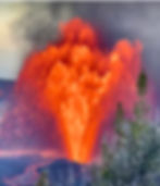 Lava erupts, shooting fire into the smoky sky past dark tree silhouettes.