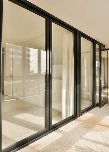 an empty room with sliding glass doors and floor to ceiling windows in a new apartment bui