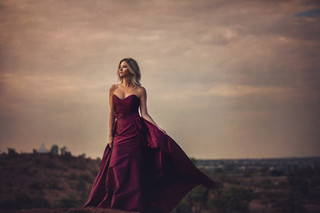 woman in red dress with the sky behind her