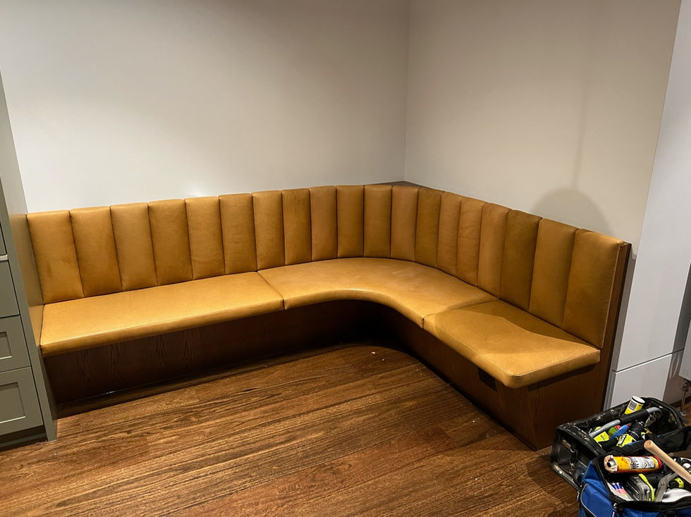 Brown leather corner sofa on wooden floor.