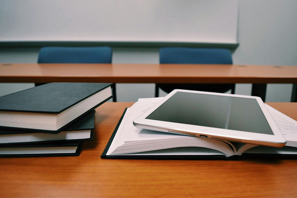 Silver ipad on white book page.