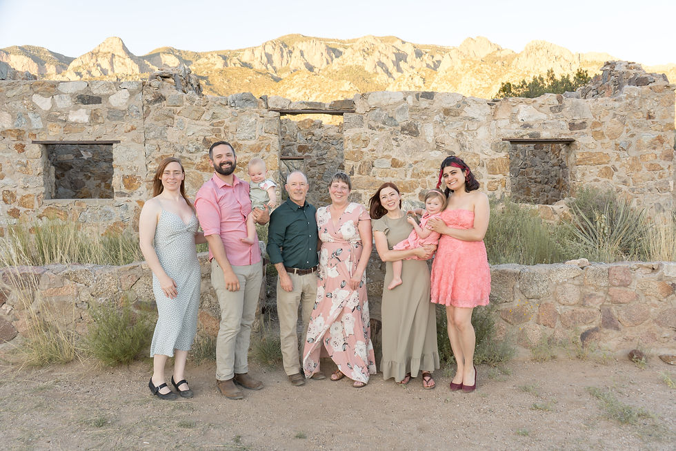 extended family picture in front of a stone cabin