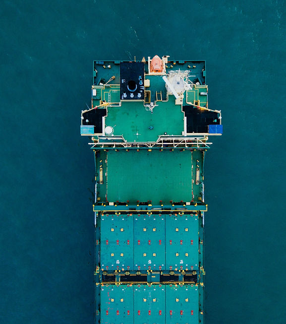 green cargo ship on body of water_edited