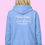 Thumbnail: Model wearing More Lake Less Stress Women's Fishing Zip Hoodie Back View