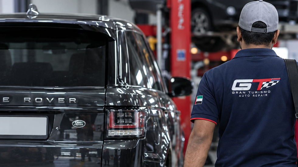 mechanic walking past Range Rover in Al Quoz workshop