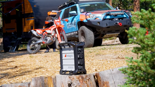 A portable power station sitting in a campsite