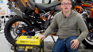 A man posing with a yellow generator