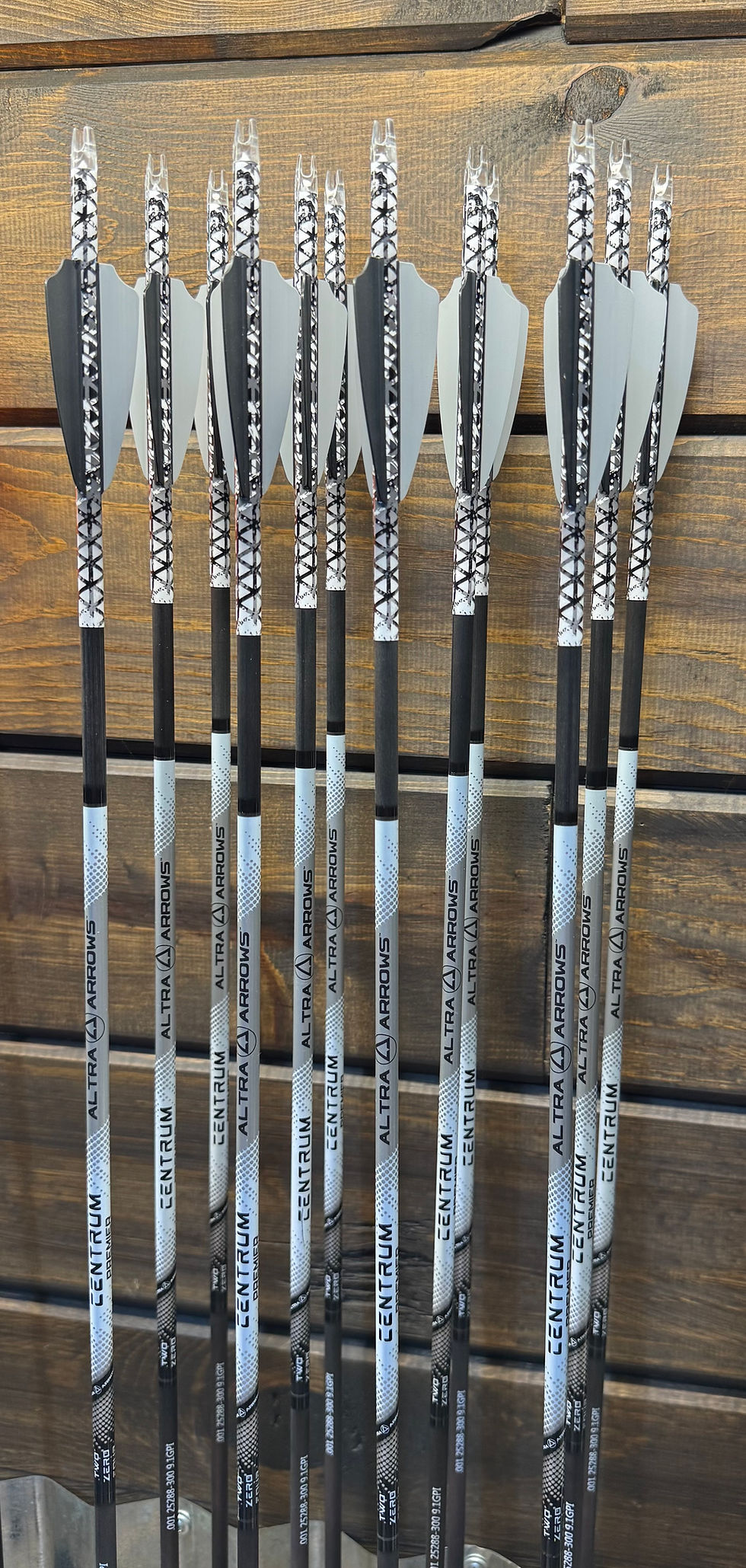Close-up of hand-fletched carbon arrows with bright fletchings