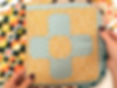 The Whatnot bag front cover which is a patchworked flower, made in a blue sitsy floral and contrast mustard ditsy floral with white accents.