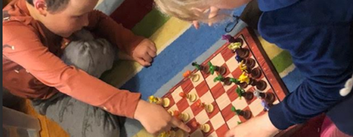 Watto's kids playing chess with early Pokemon set