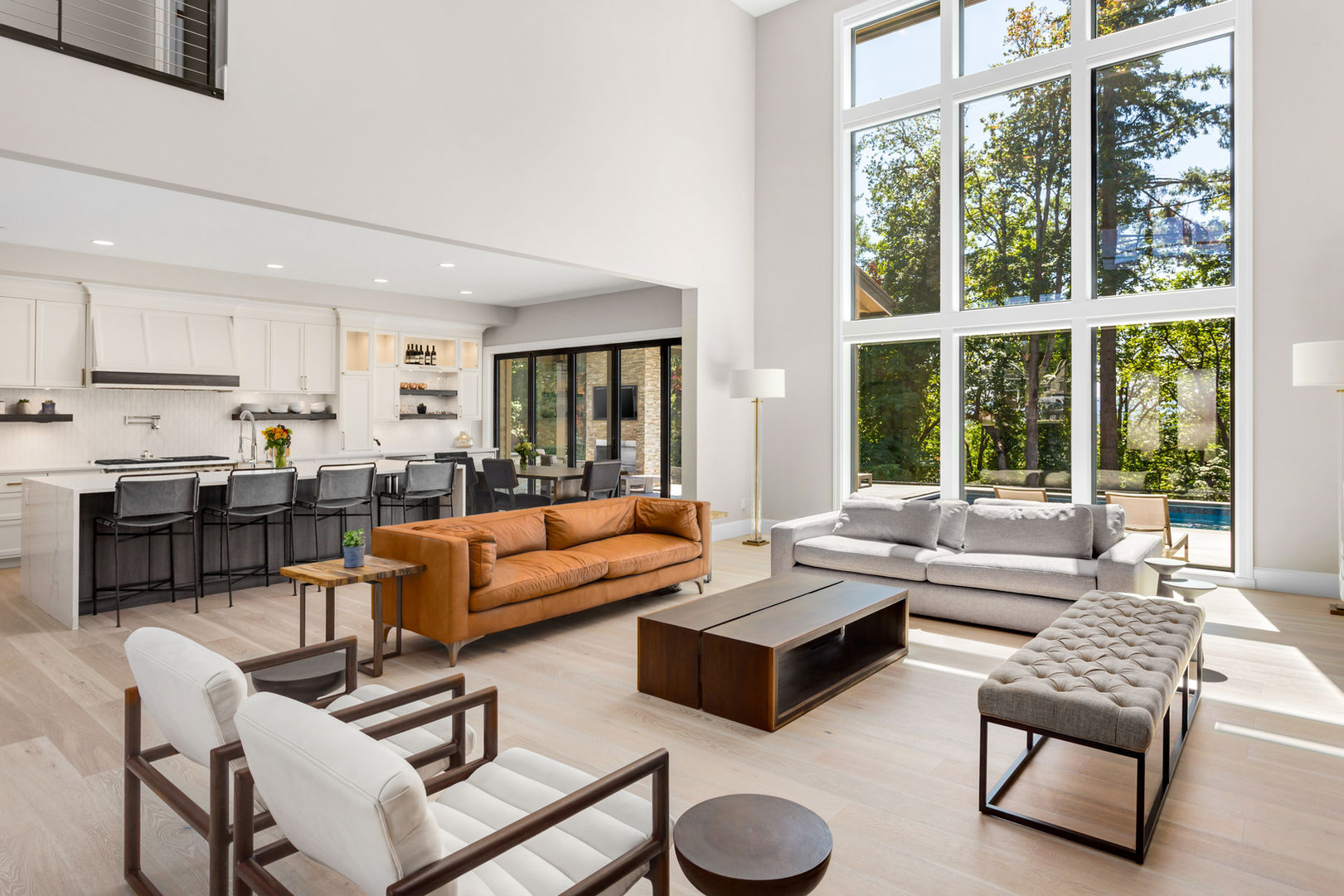 Modern open-concept living room and kitchen with large windows