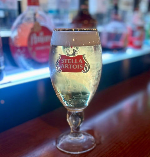 Glass of Stella Artois beer on a bar