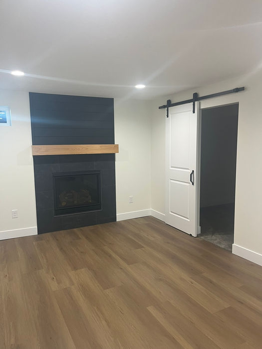 Finished basement with fireplace and barn door