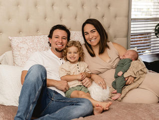 Parents with older sibling and newborn after a vaginal delivery with doula support.