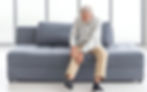 An old man experiencing gout in the knee