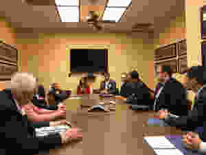 people sitting at table in a meeting