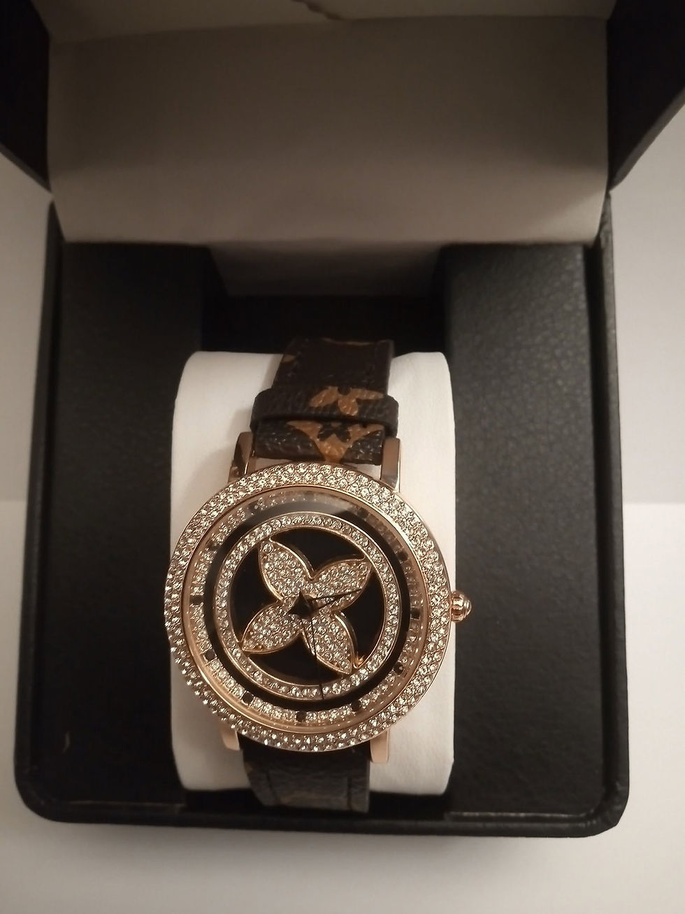 Rotating wrist watch with crystal bezel in a box