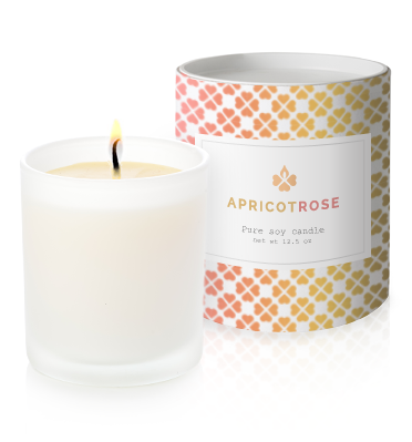 Apricot candle with lit candle
