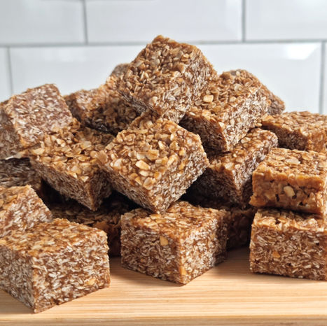 a pile of bitesize oat flapjacks on a chopping board