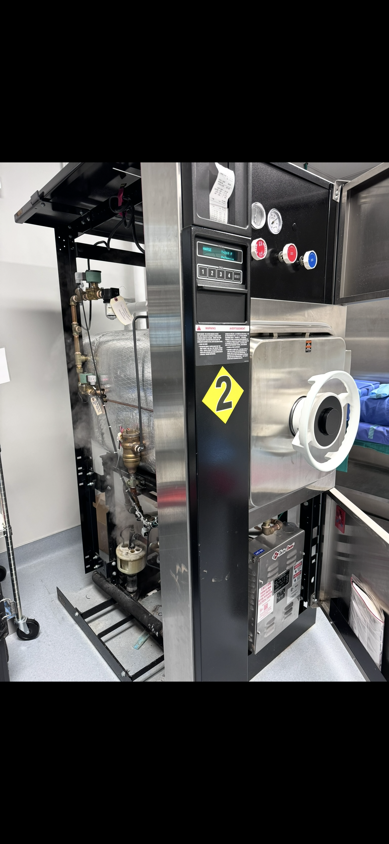 Open STERIS steam sterilizer service panel showing internal components