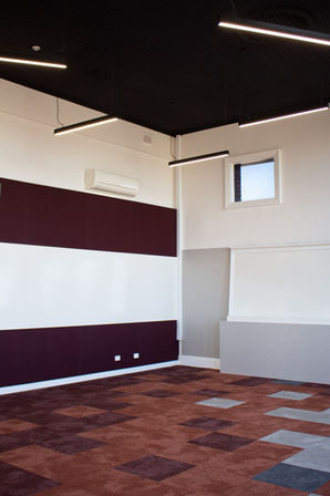 Classroom featuring WriteWall® WWL whiteboards with surrounding acoustic wall panels.