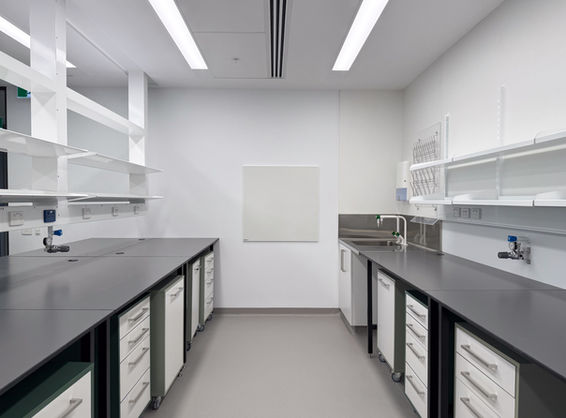 Cleanroom-style laboratory at Aikenhead Centre, fitted with a BACH whiteboard, integrated sinks, and modular storage drawers.