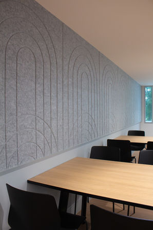 Long view of embossed/bevel cut acoustic panels along seating area.