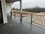 Custom black metal railing on a covered porch.