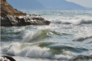 Waves crashing on beach at high tide