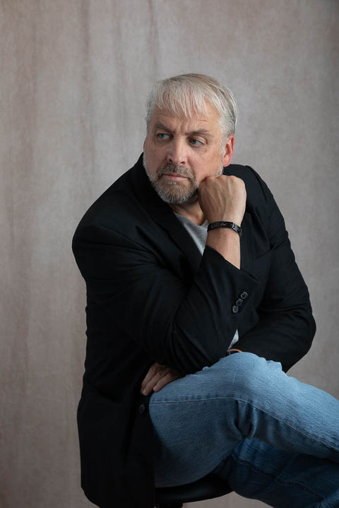 portrait of man sitting down with fist on face looking off to the side
Lynnwood personal branding photographer