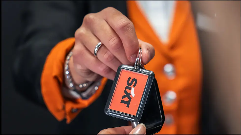 Hand holding Sixt car keys