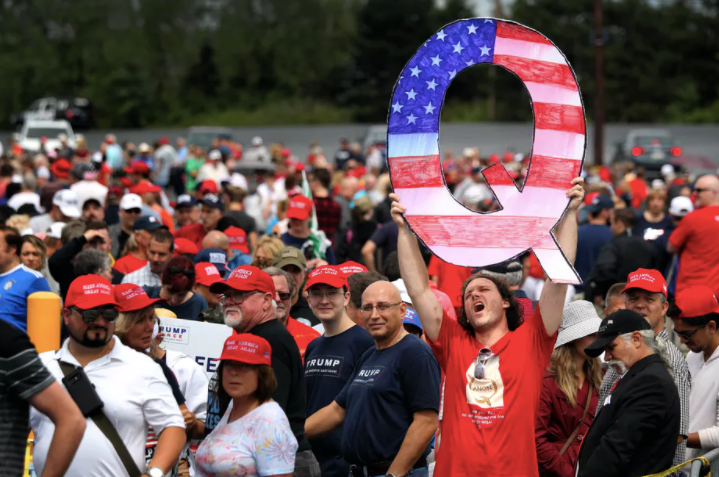 A QAnon supporter waiting to see Donald Trump at a rally in Pennsylvania. Rick Loomis/Getty Images
