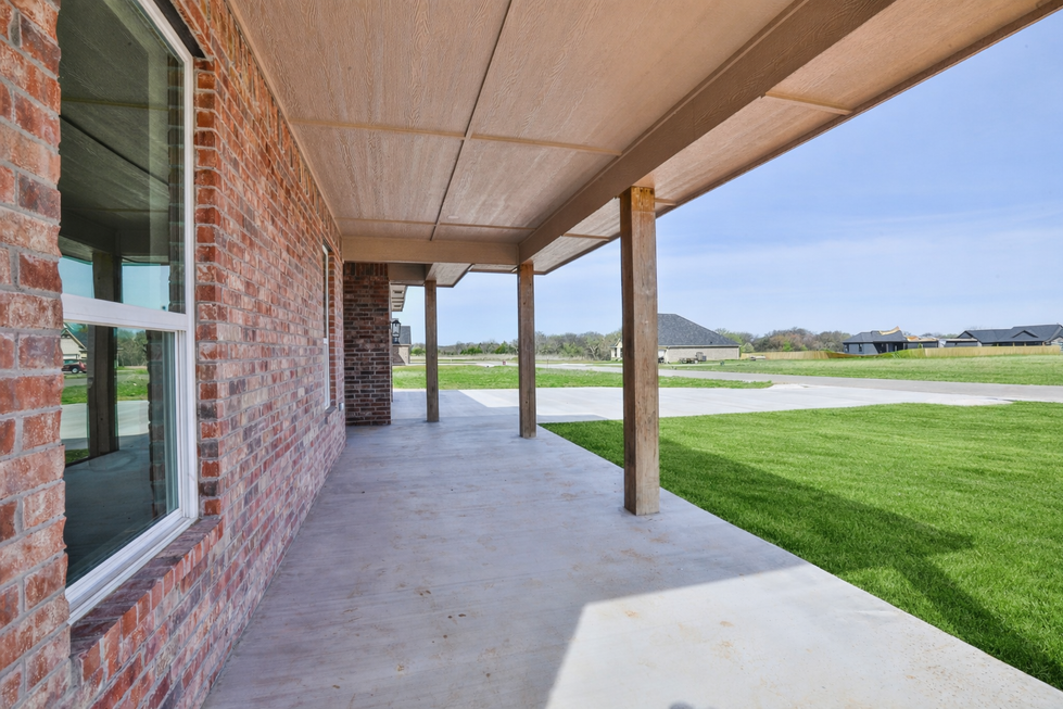 Covered porch with green lawn view
